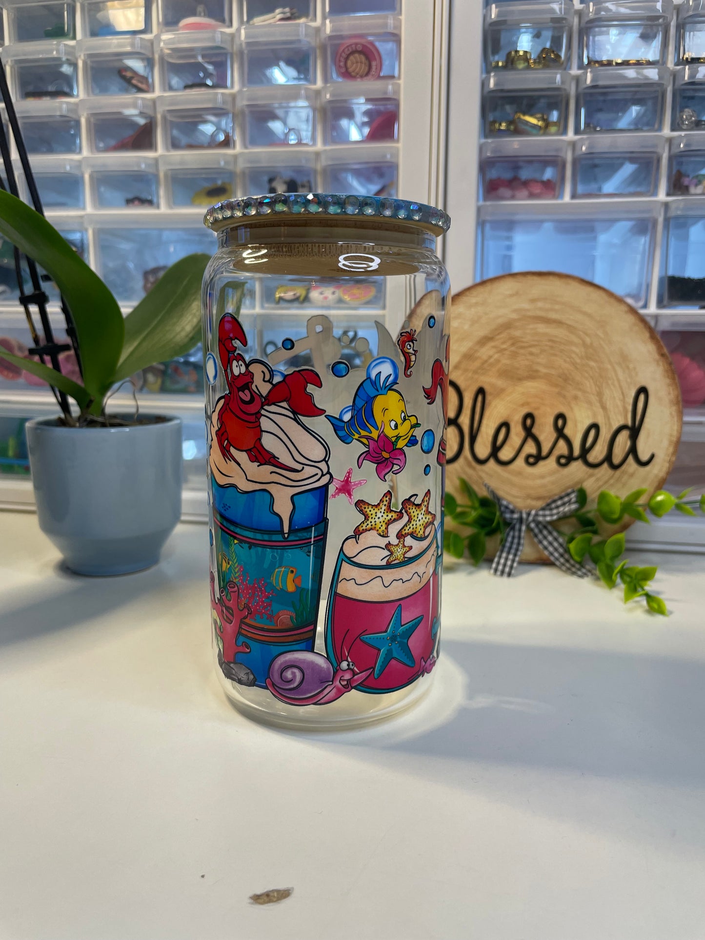 The little mermaid can glass with decorative lid.